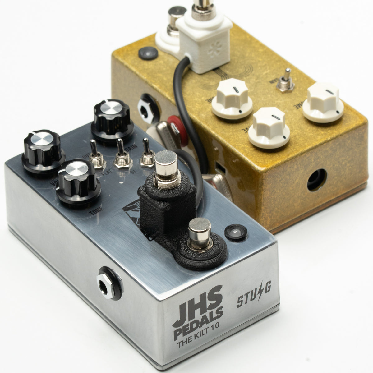 Cltchworks JS-1 v3 in Hawk Black on a silver JHS pedal, with the Michelin White version behind